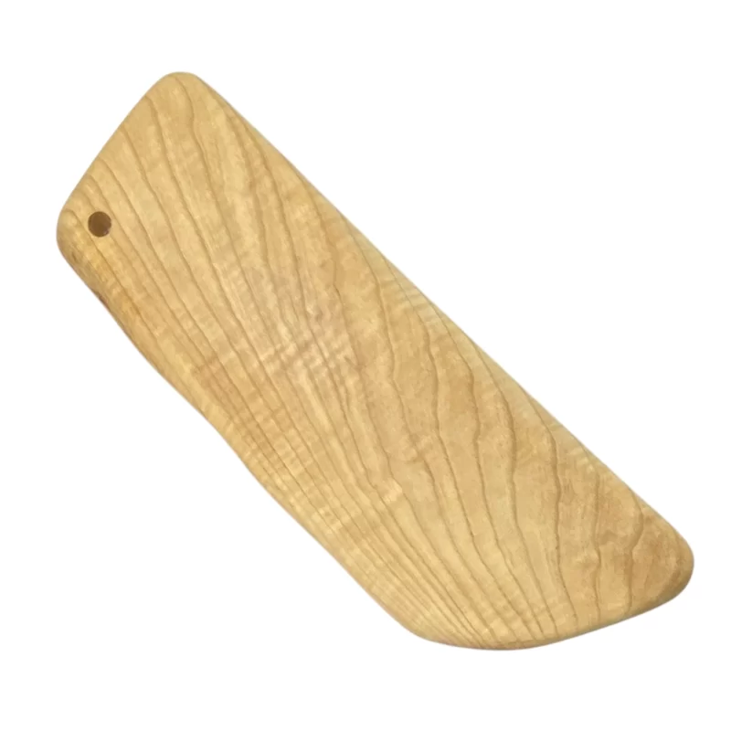 Handcrafted cutting board in solid ash wood with an irregular shape and light grain.